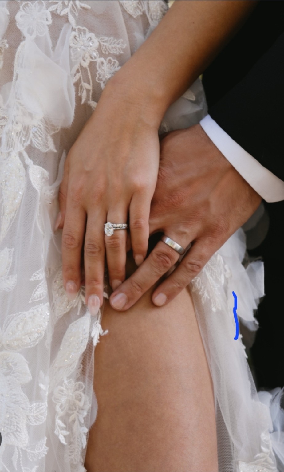 A bride and groom displaying their wedding rings